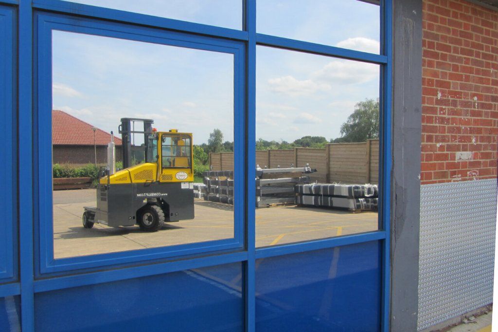 Reflection of forklift in factory window